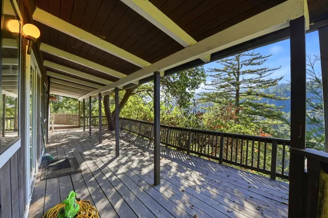 a view of a balcony with wooden floor and fence