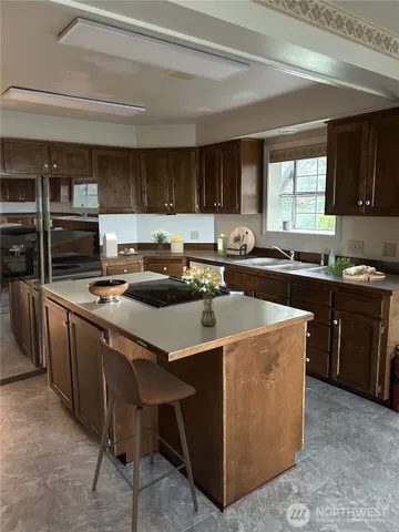 a kitchen that has a sink and a stove in it