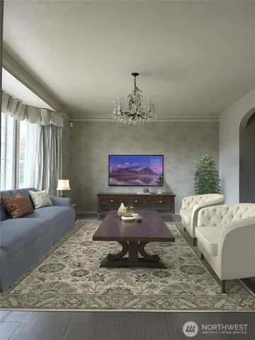 a living room with furniture and a chandelier