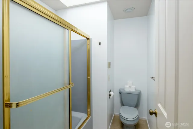 a view of a room with wooden floor and white walls