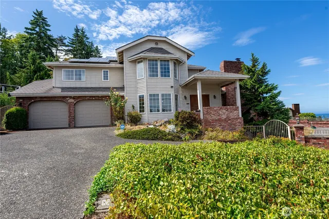 a view of swimming pool with outdoor seating and a garden