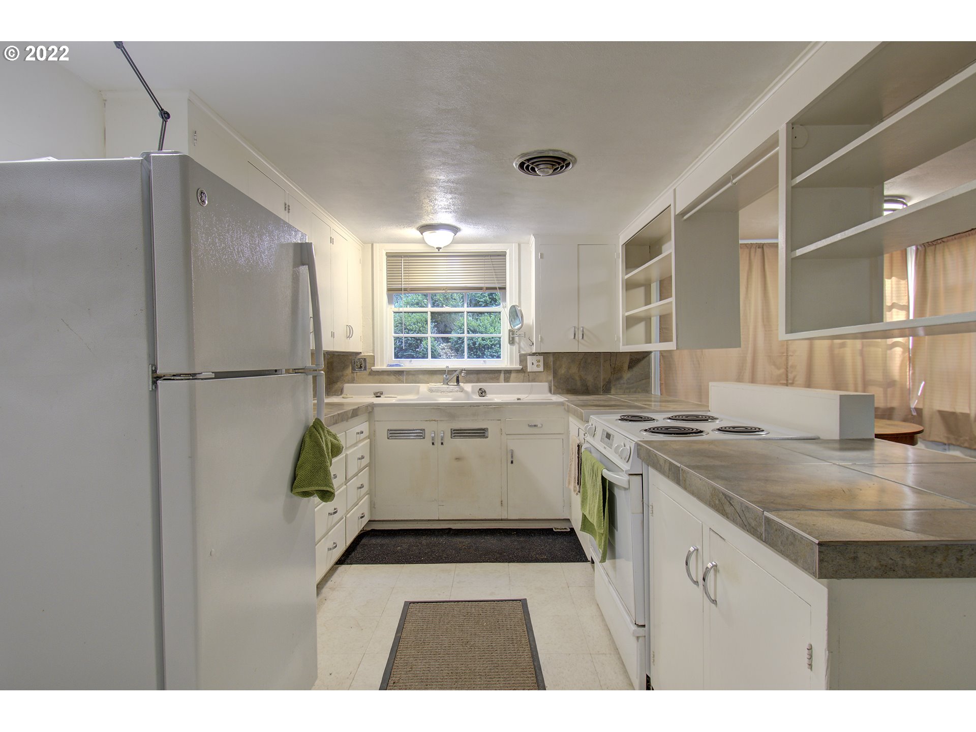 1110 Southeast Littlepage Road Corbett, OR 97019 - Photo 19 of 31 a kitchen with a stove a refrigerator and a sink