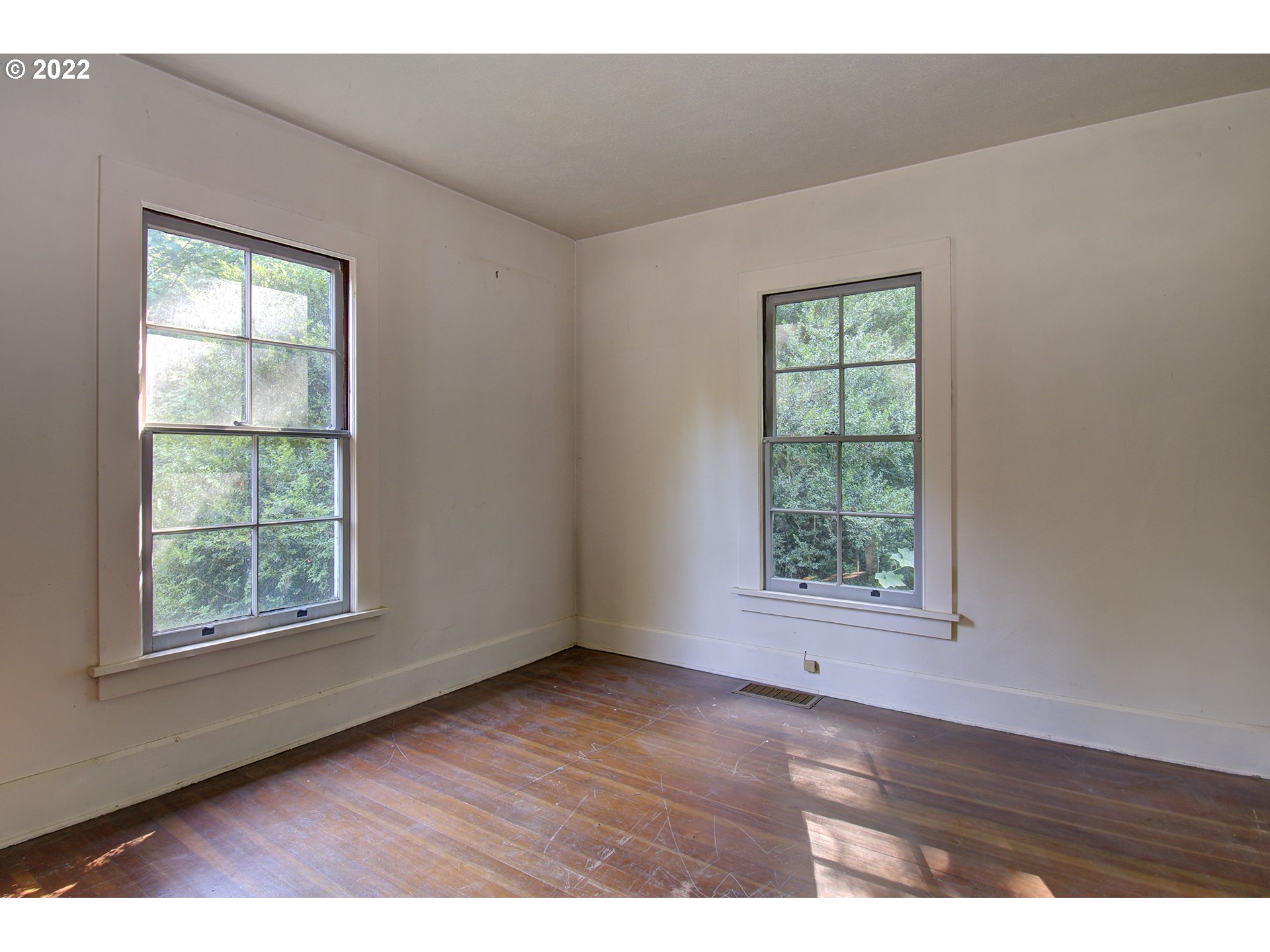 1110 Southeast Littlepage Road Corbett, OR 97019 - Photo 22 of 31 an empty room with wooden floor and windows