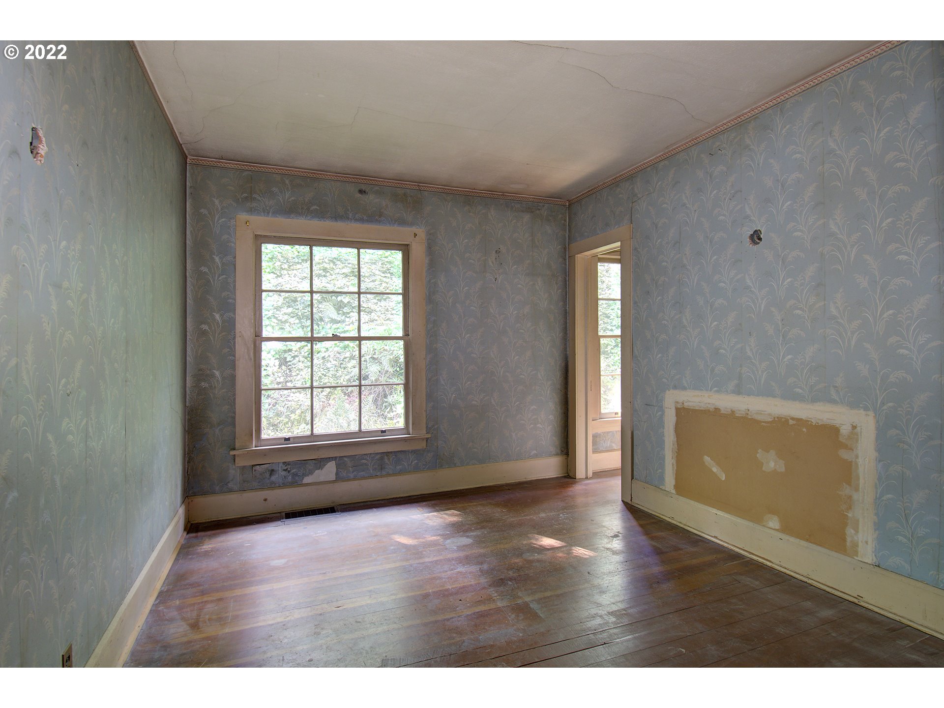 1110 Southeast Littlepage Road Corbett, OR 97019 - Photo 25 of 31 a view of an empty room with wooden floor and a window