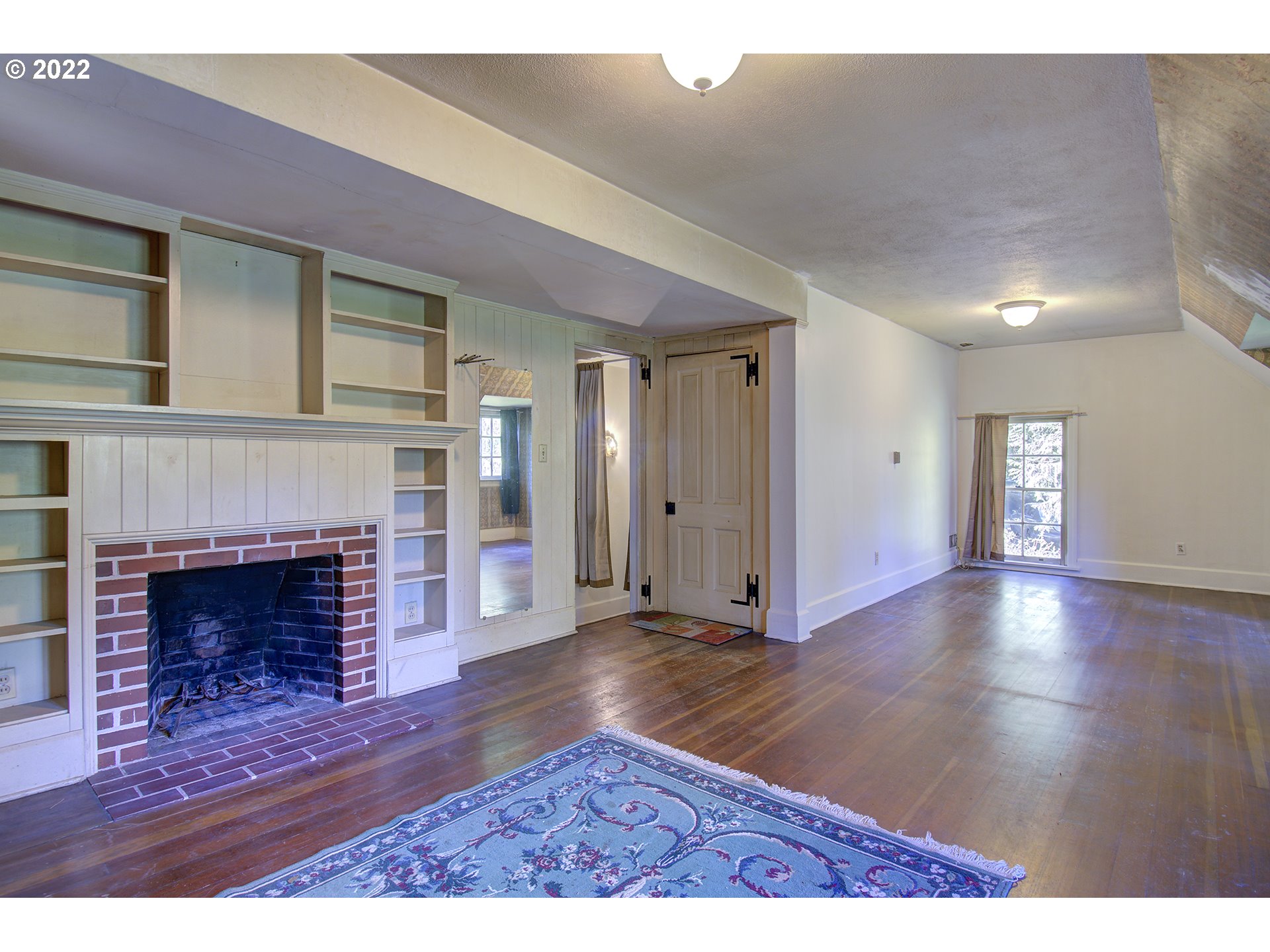 1110 Southeast Littlepage Road Corbett, OR 97019 - Photo 29 of 31 a view of an empty room with wooden floor fireplace and a window