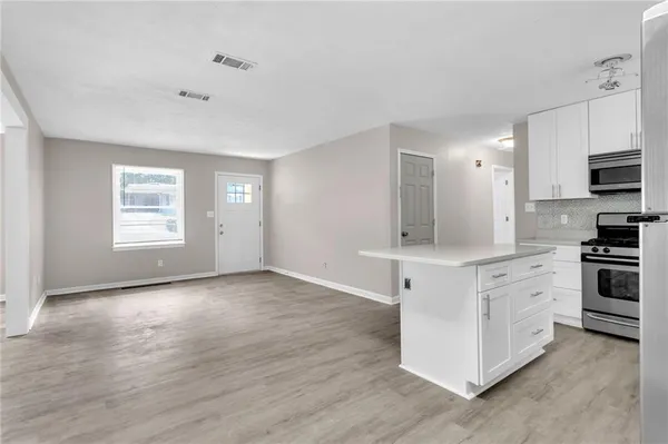 a kitchen with stainless steel appliances a stove top oven and sink
