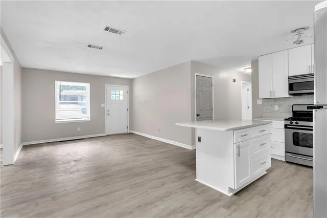 a kitchen with stainless steel appliances a stove top oven and sink