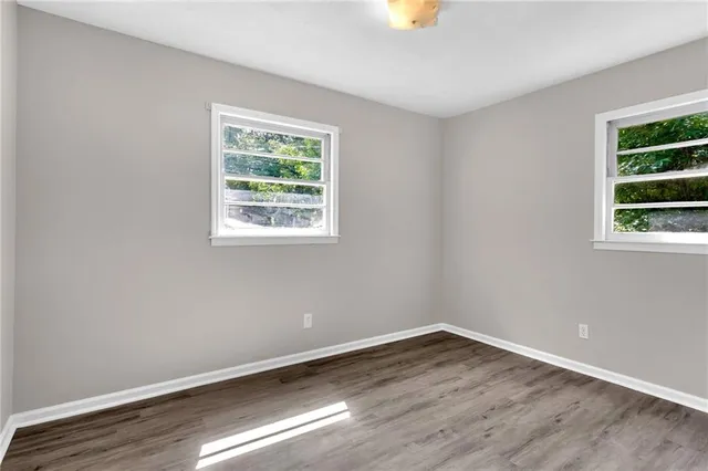 wooden floor in an empty room with a window