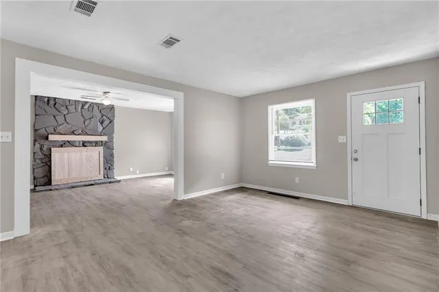 an empty room with windows and cabinet