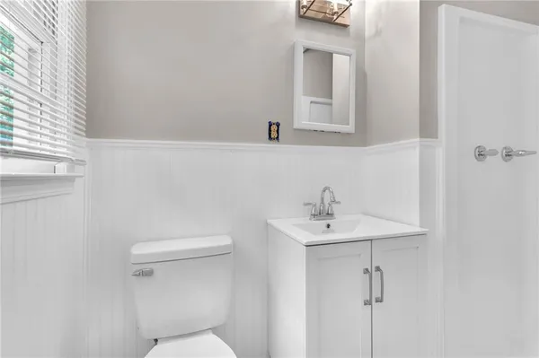 a bathroom with a sink a mirror and a toilet