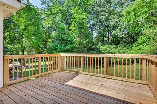 a view of balcony with wooden floor and fence