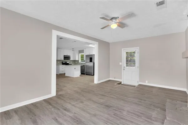 a view of kitchen with wooden floor and window
