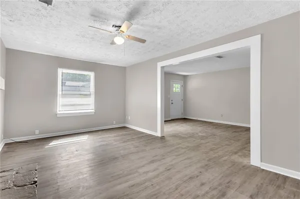 wooden floor in an empty room with a window
