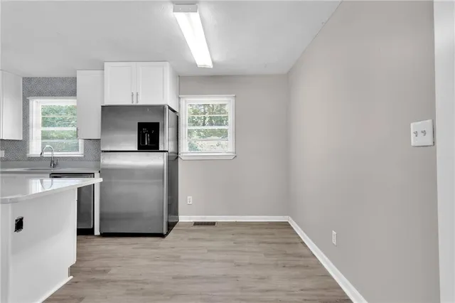 a kitchen with cabinets appliances and a window
