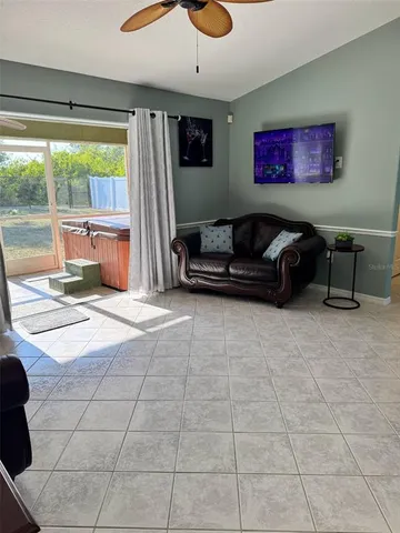 a living room with furniture and a floor to ceiling window