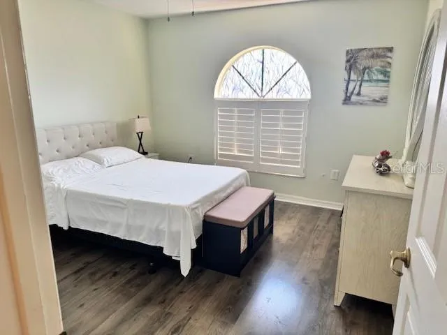 a bed sitting in a bedroom next to a window