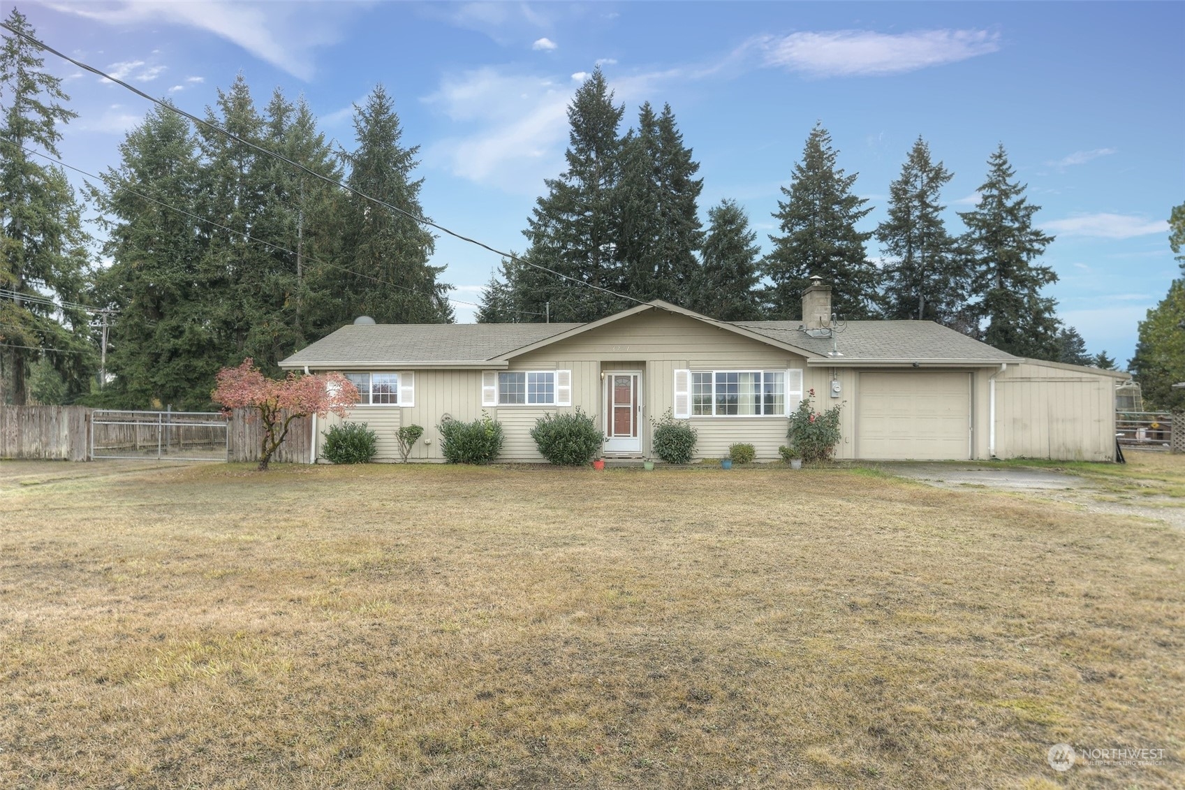 6721 183rd Avenue Southwest Rochester, WA 98579 - Photo 1 of 18 a front of a house with a yard and trees