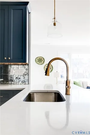 a kitchen with a sink a stove and cabinets