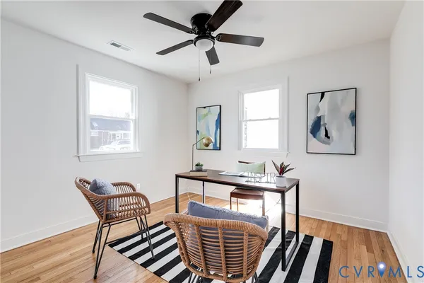 a view of a workspace with furniture window and wooden floor