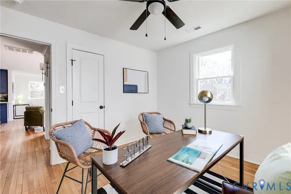 a view of a dining room with furniture and wooden floor