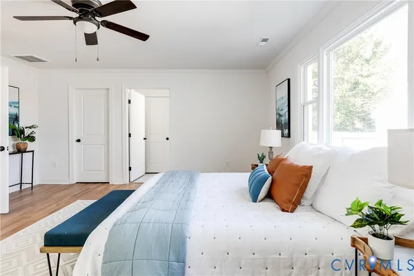 a bedroom with a bed and a potted plant