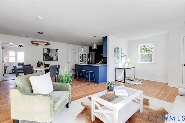 a living room with furniture and kitchen view