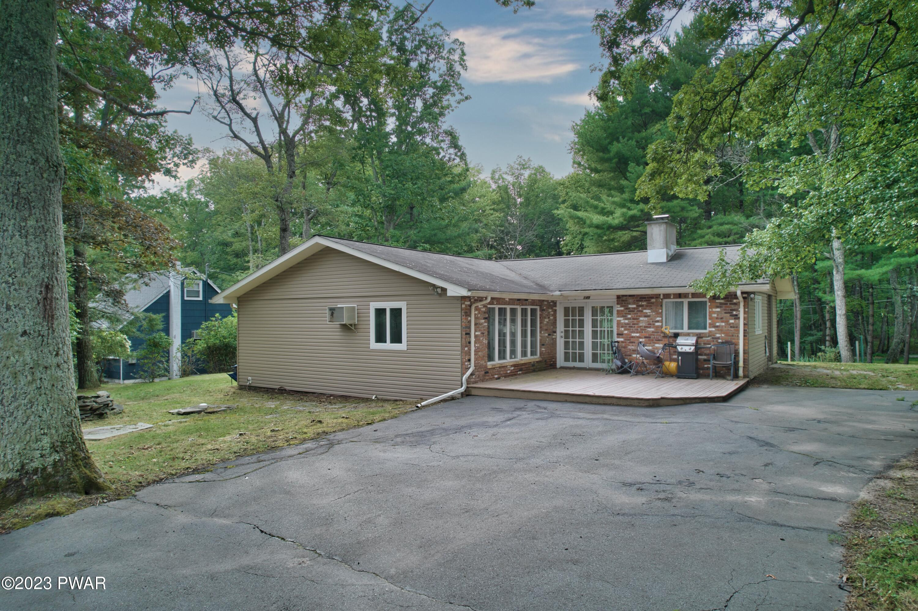 149 Walker Lake Road Shohola, PA 18458 - Photo 50 of 51 a view of a house with a yard and large trees