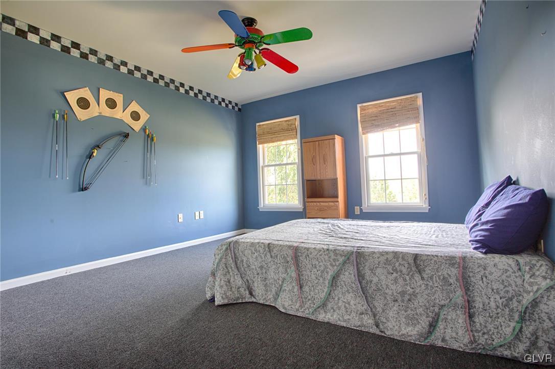 724 South Delps Road Bath, PA 18014 - Photo 16 of 23 a bedroom with a bed and a chandelier