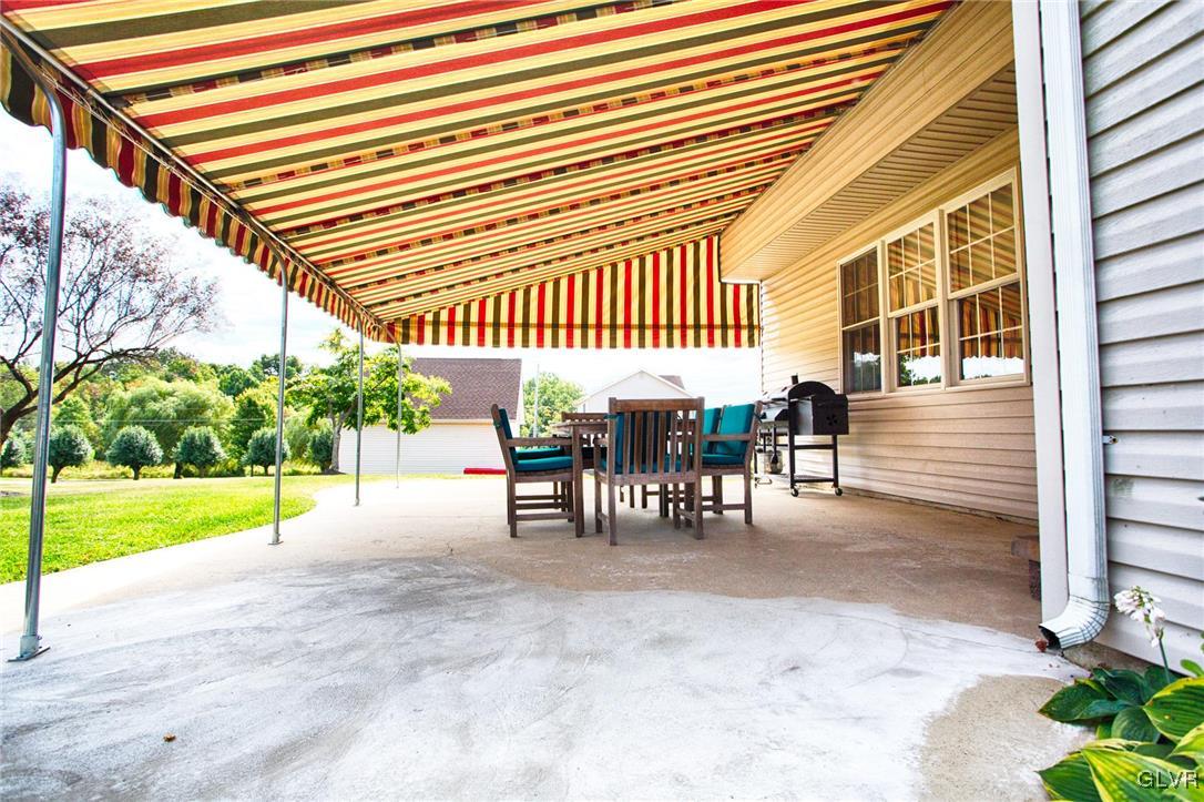 724 South Delps Road Bath, PA 18014 - Photo 22 of 23 a view of a patio with table and chairs with wooden floor and fence