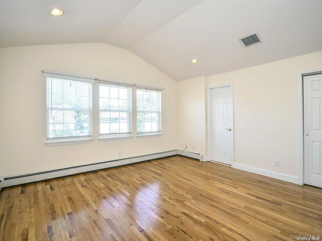 34 Firwood Road, Unit B Port Washington, NY 11050 - Photo 9 of 25 a view of an empty room with wooden floor and a window