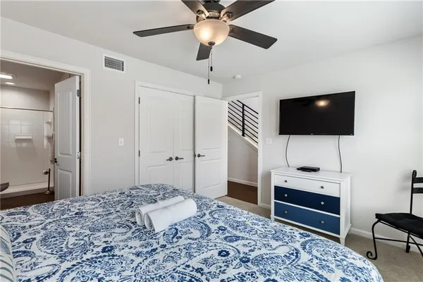 a bedroom with a bed and a flat screen tv