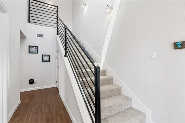 a view of entryway and hall with wooden floor