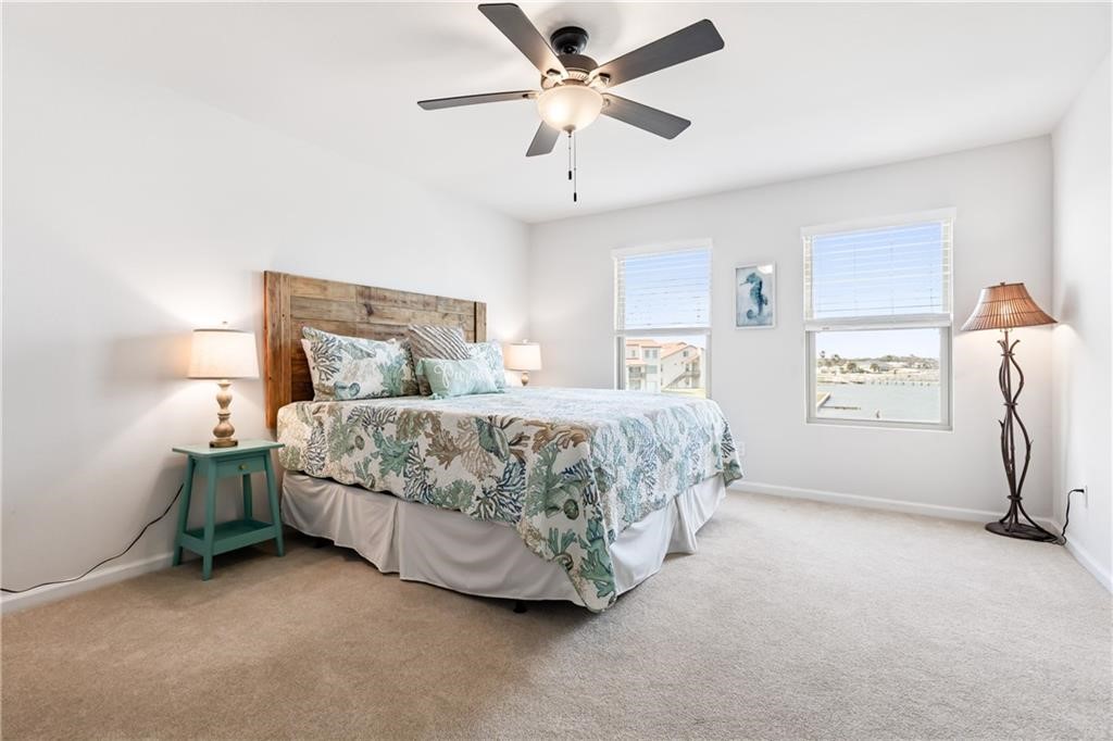 620 South Fulton Beach Road, Unit 308 Rockport, TX 78382 - Photo 18 of 30 a bedroom with a bed chandelier and a window