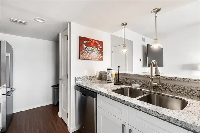 a kitchen with a sink a refrigerator and window