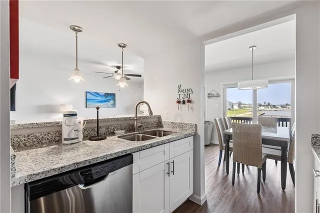 a kitchen with center island appliances and wooden floor
