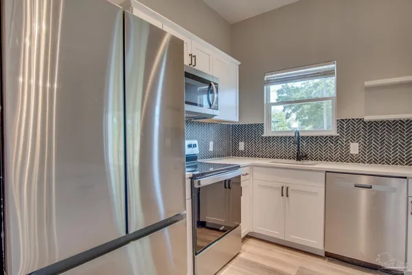 a kitchen with cabinets and window