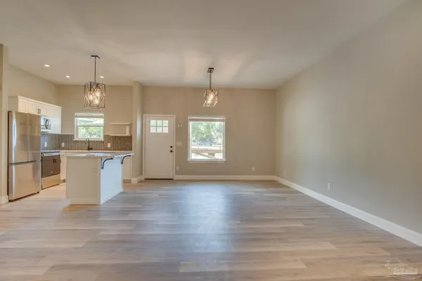 a view of a kitchen with a sink cabinets and wooden floor