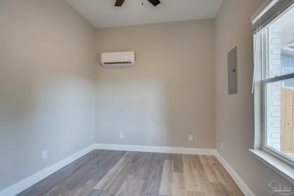 wooden floor in an empty room with a window