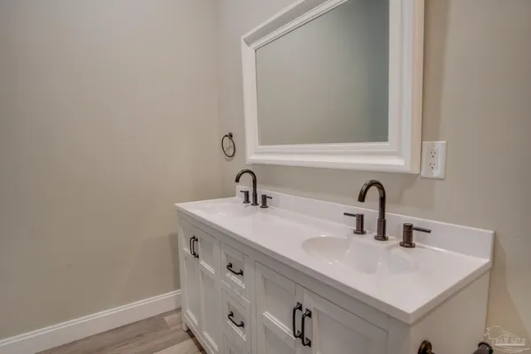 a bathroom with a sink toilet vanity and mirror