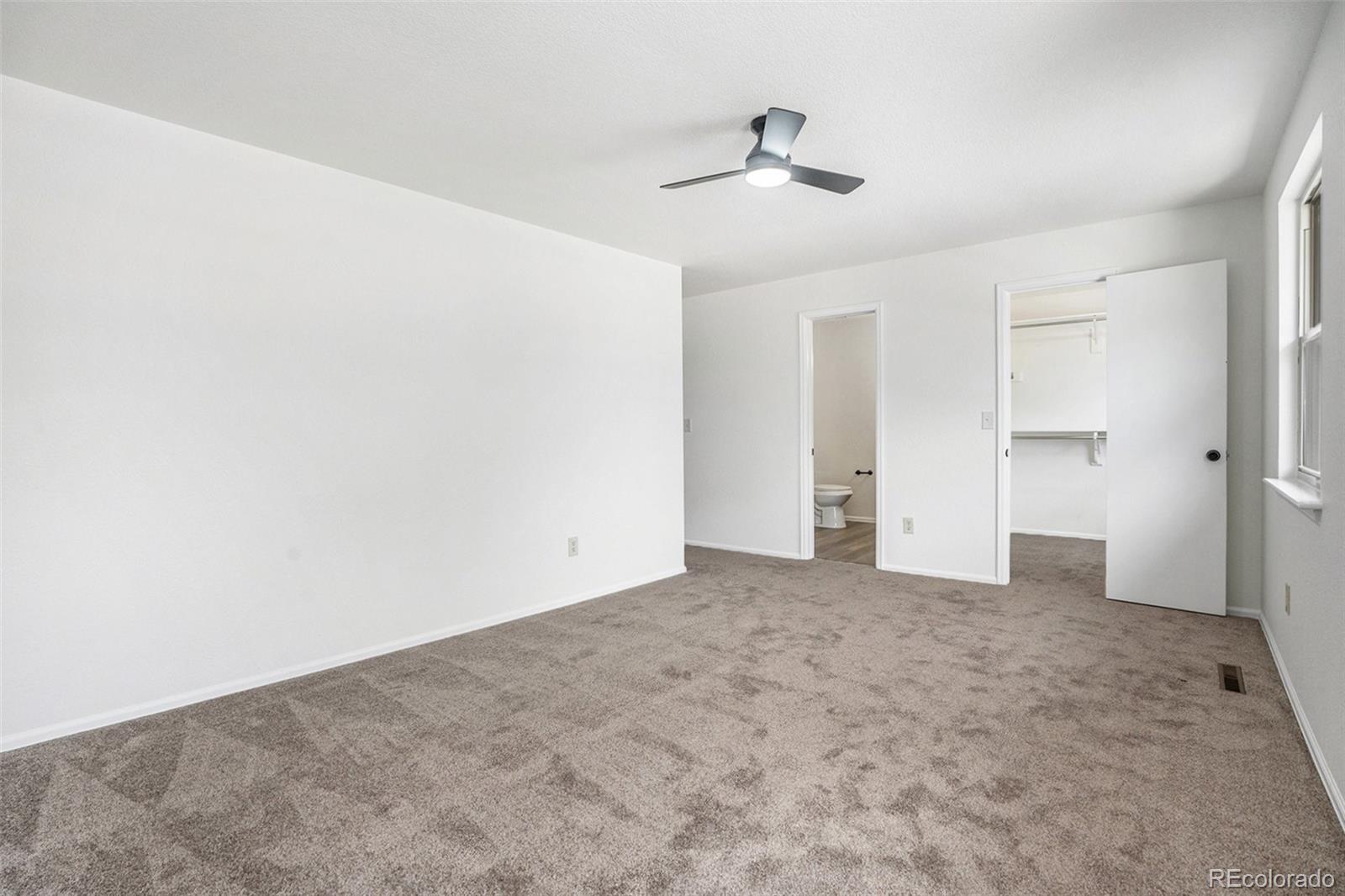 6075 Castlewood Lane Colorado Springs, CO 80918 - Photo 13 of 23 an empty room with closet and a chandelier fan