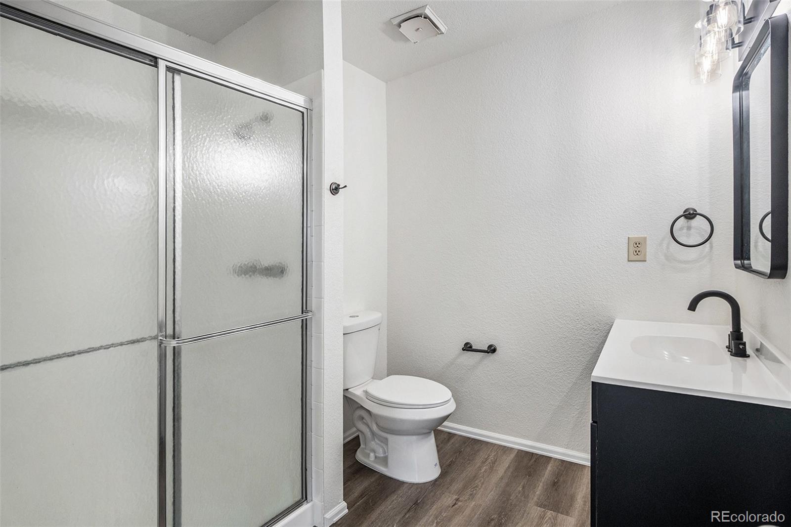 6075 Castlewood Lane Colorado Springs, CO 80918 - Photo 14 of 23 a bathroom with a toilet sink and shower