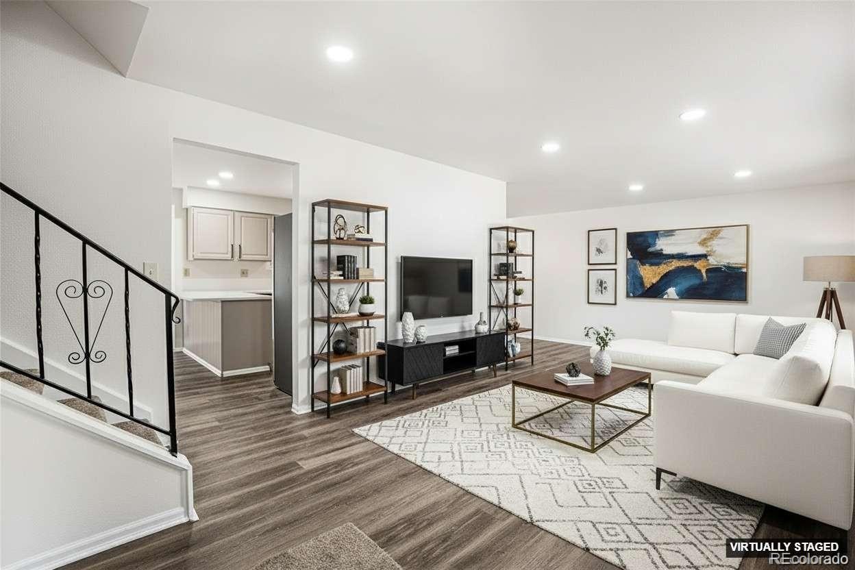 6075 Castlewood Lane Colorado Springs, CO 80918 - Photo 3 of 23 a living room with furniture and a flat screen tv