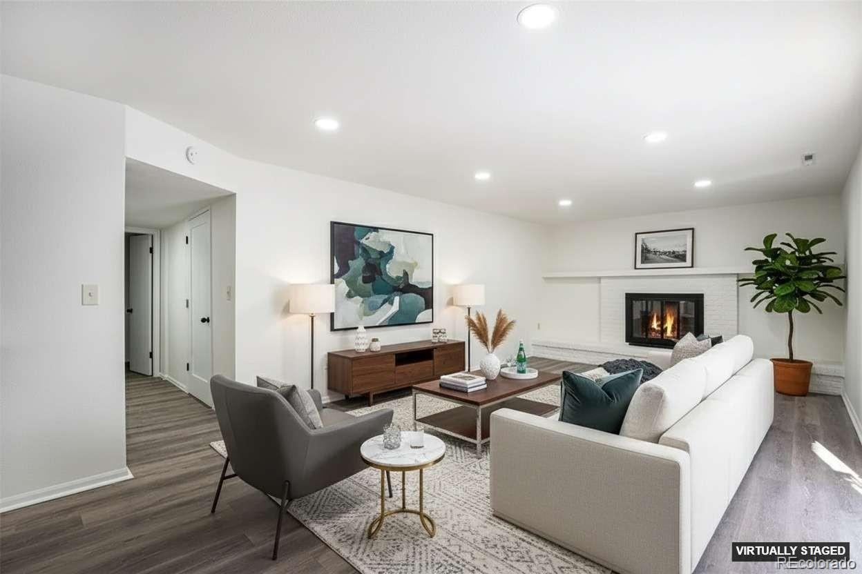 6075 Castlewood Lane Colorado Springs, CO 80918 - Photo 8 of 23 a living room with furniture and a fireplace