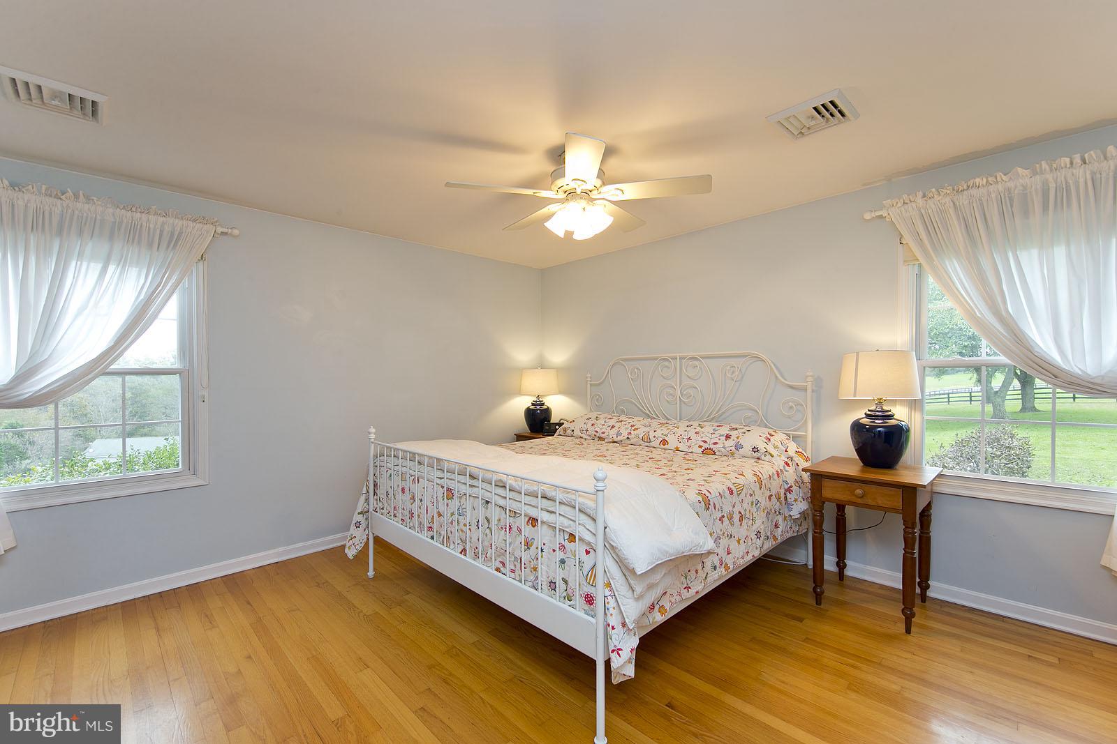 2360 Hunting Ridge Road Winchester, VA 22603 - Photo 12 of 30 a bedroom with a bed and a chandelier