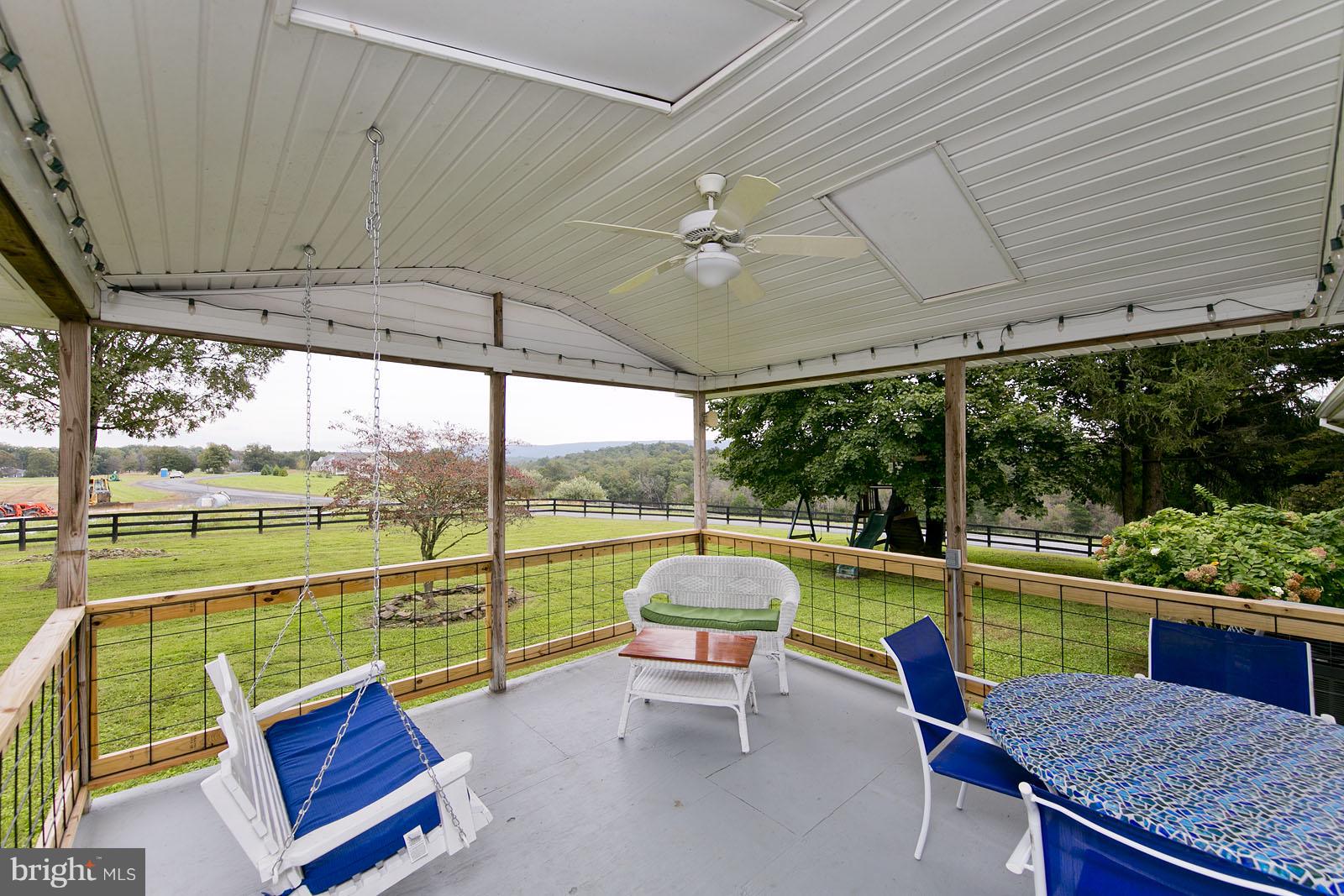 2360 Hunting Ridge Road Winchester, VA 22603 - Photo 23 of 30 a view of a chairs and table in the patio next to a yard