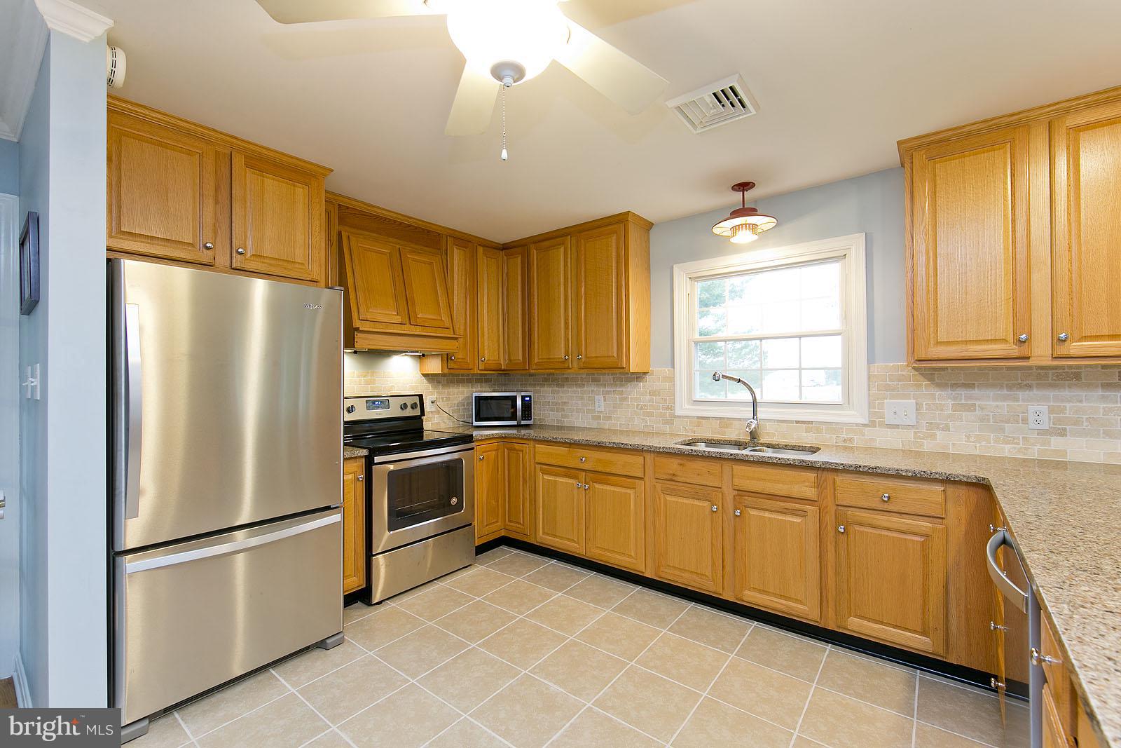 2360 Hunting Ridge Road Winchester, VA 22603 - Photo 4 of 30 a kitchen with stainless steel appliances granite countertop a refrigerator sink and cabinets