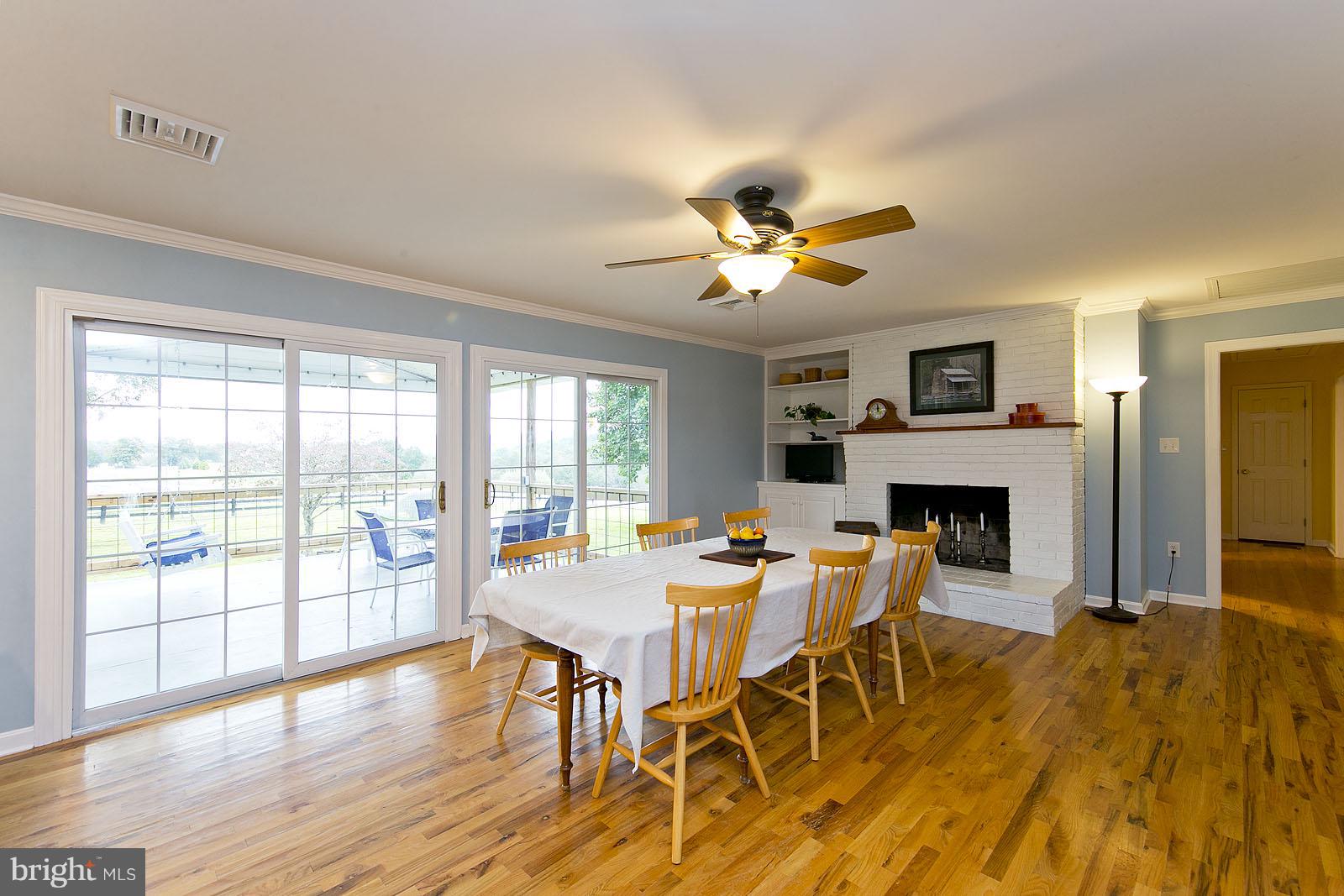 2360 Hunting Ridge Road Winchester, VA 22603 - Photo 6 of 30 a view of a dining room with furniture a fireplace and wooden floor