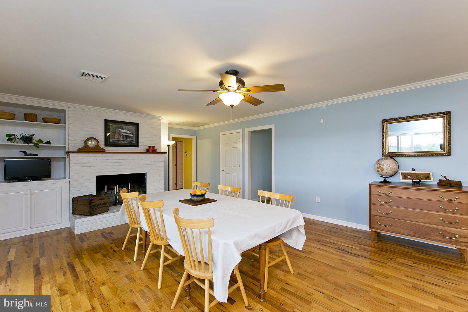 2360 Hunting Ridge Road Winchester, VA 22603 - Photo 7 of 30 a view of a dining room with furniture a fireplace and chandelier