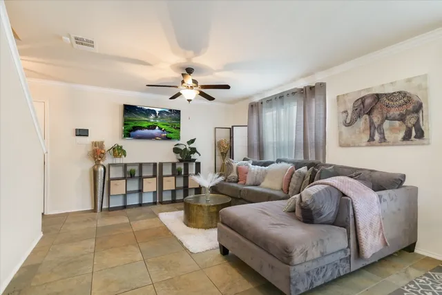 a living room with furniture and a chandelier