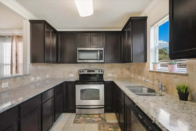 a kitchen with a sink stove and microwave
